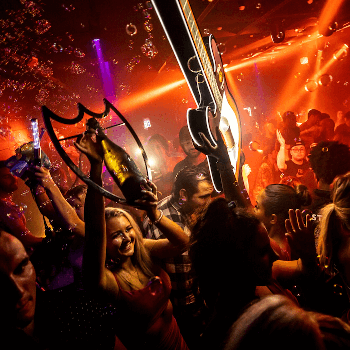 People partying in a club getting bottle service in Miami, FL